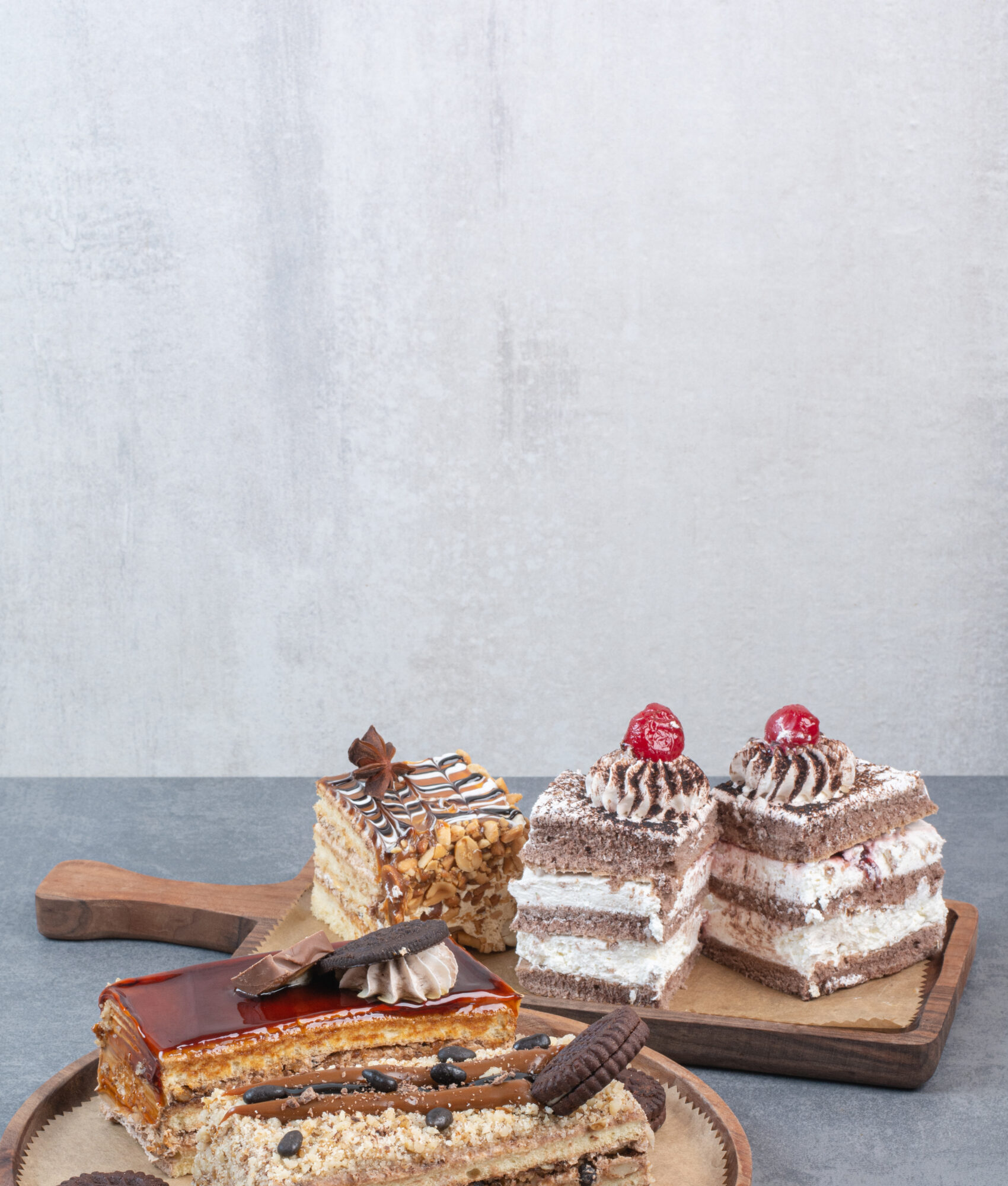 A lot of piece of cakes with cookies on wooden cutting board. High quality photo