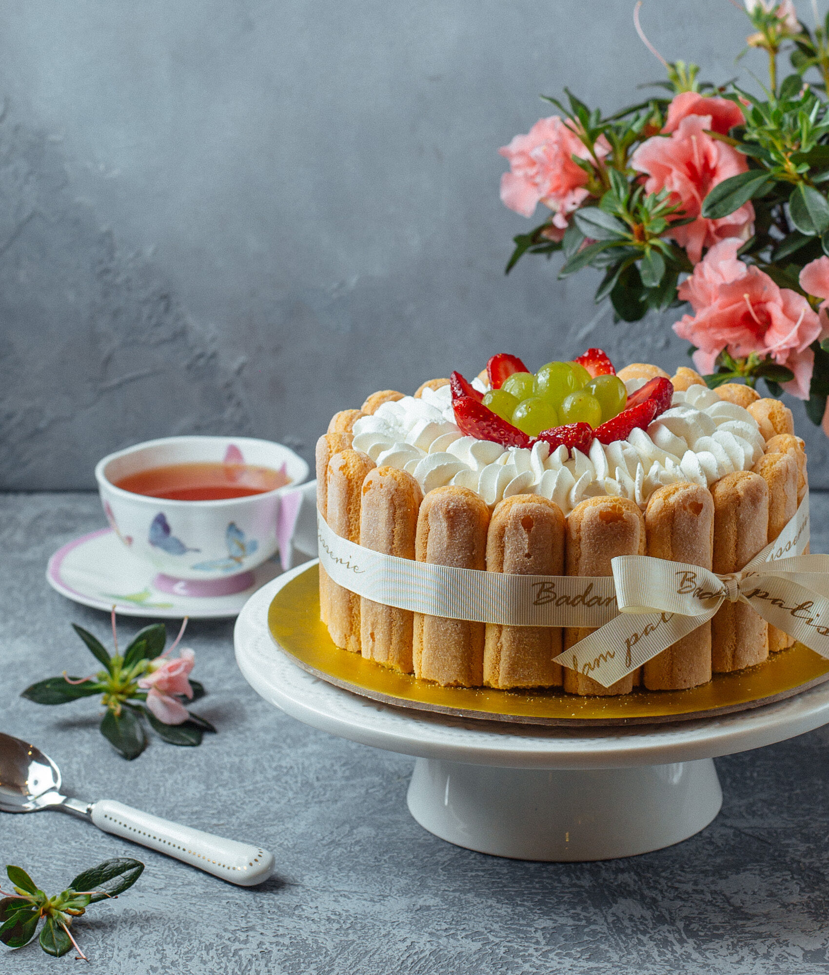 tiramisu-cake-with-lady-finger-cookies-berries-with-cup-tea-flowers